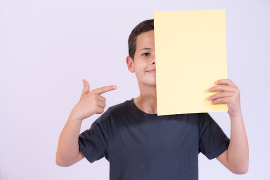 Smiling Boy Portrait Holding Blank Paper In Half Face Over White Background