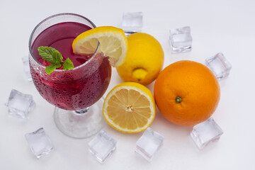 Refreshing cocktail (Red Summer Wine) on white methacrylate background. Concept of fun and social life in bars and pubs. Horizontal photo and selective focus