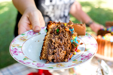 Woman delivering piece of chocolate cake.
