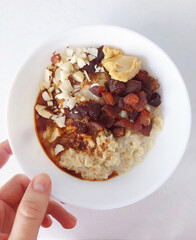 healthy breakfast plate. porridge with candied nuts, nut paste, syrup. food photos
