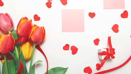Postcard with a bouquet of tulips on a white background. Space, text message. Holiday card for Valentine's Day, Women's Day, Mother's Day! Top view, flat lay. Happy birthday.