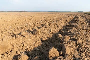 Deep furrows in the ground after working the tractor with the plow. Plowing the land. treatment of...