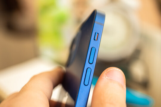 Kharkov, Ukraine - April 27, 2021: Apple iPhone 12 volume buttons close-up, side silence slider