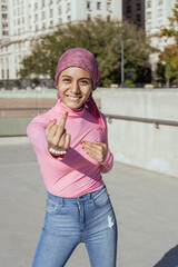 Young woman with breast cancer showing strength and fighting disease. Hope in her smile. Hope, Struggle, Empowerment Concept.