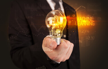 Businessman holding a lightbulb concept