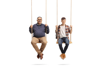 Father and teenage student son sitting on wooden swings