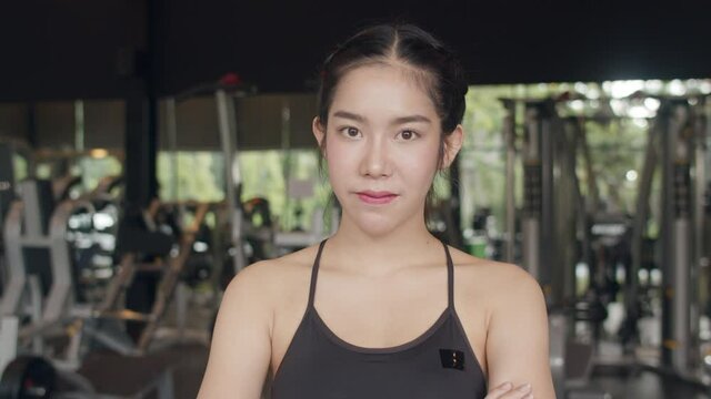 Happy Asian healthy sport woman trainer with sportswear smile looking at camera feel cheerful and fresh after workout in gym, People training use in fitness class, sport and healthy lifestyle concept.