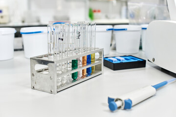 glass test tubes with liquids of different colors are on the table in a chemical laboratory