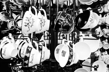 Brittany, France. Traditional cider cups decorated with Breton symbols at souvenir shop display. Black white historic photo.