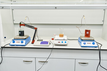 chemical laboratory equipment stands on a white table