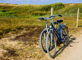 Fototapeta na wymiar Two bicycles in countryside. Brittany, France. The concept of romance, love and simple everyday life. Travel background