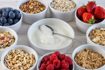 granola and cereals, various delicious ingredients for breakfast in bowls