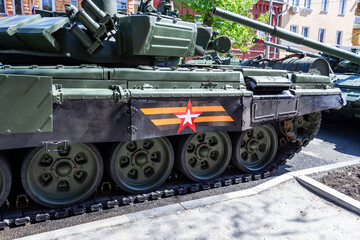Fototapeta premium Samara, Russia - May 06, 2021: Tracks of a Russian T-72B3 Ural battle tank parked on a city street