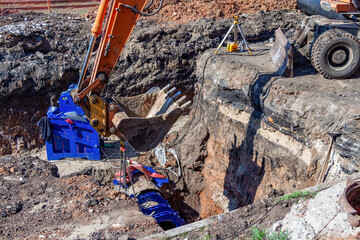 Samara, Russia - May 06, 2021: Excavator bucket close-up performs excavation work on a construction...