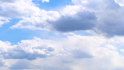 Naklejka na ściany i meble Beautiful blue spring sky with wind-blown clouds