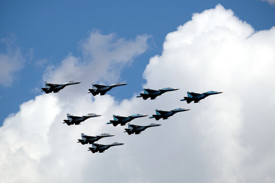 MOSCOW, RUSSIA - MAY 7, 2021: Group of Russian military supersonic high-altitude interceptors SU-34, SU-35, SU-30SM shows figure Tactical Wing in flight on parade rehearsal