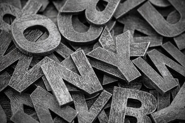Pile of old vintage wooden letters. Typography background composition.