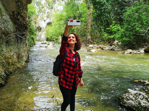 Woman taking selfie on the Aterno river, Raiano, Abruzzo