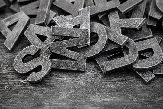 Pile of old vintage wooden letters. Typography background composition.