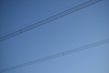 High-voltage power lines in the blue sky