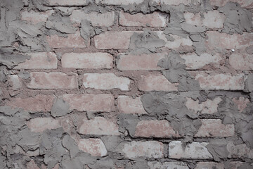 Non-linear pattern of an shabby brick wall with natural patterns of paint chips. Restoration of semi-antique brick walls. A basic neutral background for a design project.