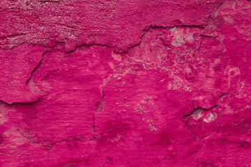 Texture of the pink stucco wall with scratches, cracks, dust, crevices, roughness. Can be used as a poster or background for design.