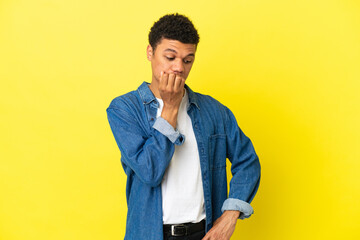 Fototapeta premium Young African American man isolated on yellow background having doubts