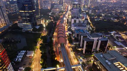 Naklejka premium Aerial view of highway intersection and buildings in the city of Jakarta at night and noise cloud with Jakarta cityscape. Jakarta, Indonesia, May 8, 2021