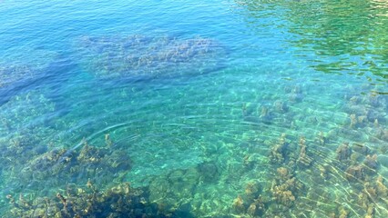 Fototapeta na wymiar Turquoise sea clean rippled water background. Blue clear waters. Zen, meditation, relax, summertime in paradise beach.