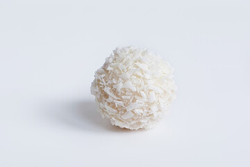 Sweet ball, white Chocolate candies covered in shredded coconut on white background. Handmade...