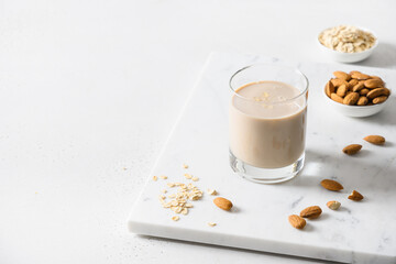 Almond and oatmeal milk on white background. Lactose free. Close up. Close up. Lack of cholesterol. Plant based milk.