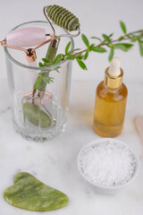 Face roller and guasha massager. Facial skin care, anti age products, sea salt and essential oil. Chinese Gua Sha massage tools from rose quartz and nephrite. 