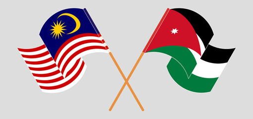 Crossed and waving flags of Malaysia and Jordan