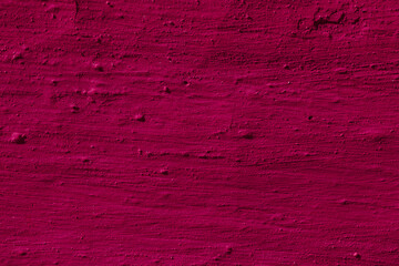 Texture of the dark pink stucco wall with scratches, cracks, dust, crevices, roughness. Can be used as a poster or background for design.