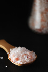 A wooden spoon with pink Himalayan salt