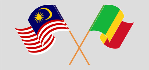Crossed and waving flags of Malaysia and Mali