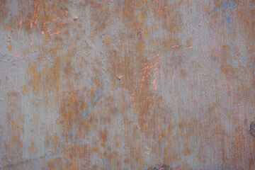 Gray rough background with peeling paint and color streaks. Surface with scratches, chips and colored lines. Elements of corrosion and fading.