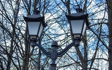 Classic old fashioned street lamp light at dusk. Light pole. Street lighting.