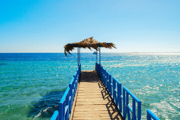 Egypt, Safaga, Africa, A luxurious pier in the middle of the turquoise Red Sea. Wonderful hot day, vacation on the beach.