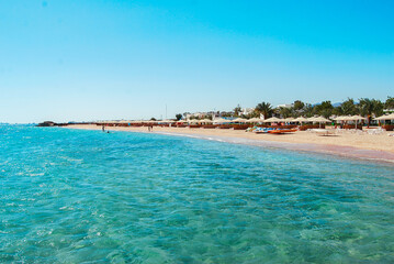 Fototapeta na wymiar Egypt, Safaga, Red Sea coast, waves, blue lagoon, white sand, sunny day, vacation by the sea.