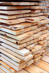 A bunch of planks stacked one-on-one. Background of wooden board. Natural wood texture