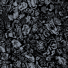 Grey footprints on black backdrop. Seamless texture
