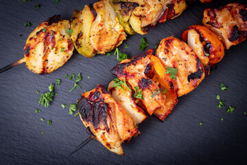 Raw chicken skewers in marinade with spices and herbs
