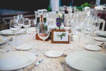 Beautiful elegant table setting in a wedding, the table have the name of a wine type, the chardonnay