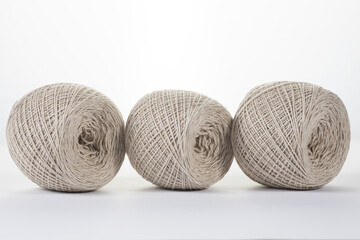 ball of gray cotton yarn on white background