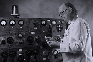 Scientist working in its laboratory, doing a physics experiment, checking his calculations with a slide rule