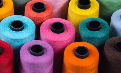 Multi-colored spools of thread. Close-up. View from above