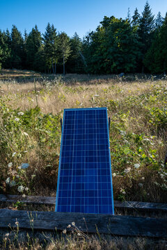 A solar panel charges in the sunshine on an off-grid island