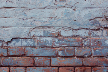 Old brick wall with cracks, cement and blue plaster Can be used as a poster or background for design. 