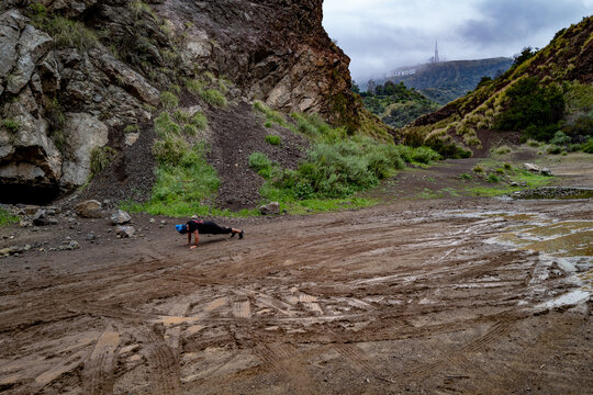A man does pushups while cross training in Bronson Canyon, Los Feliz, California